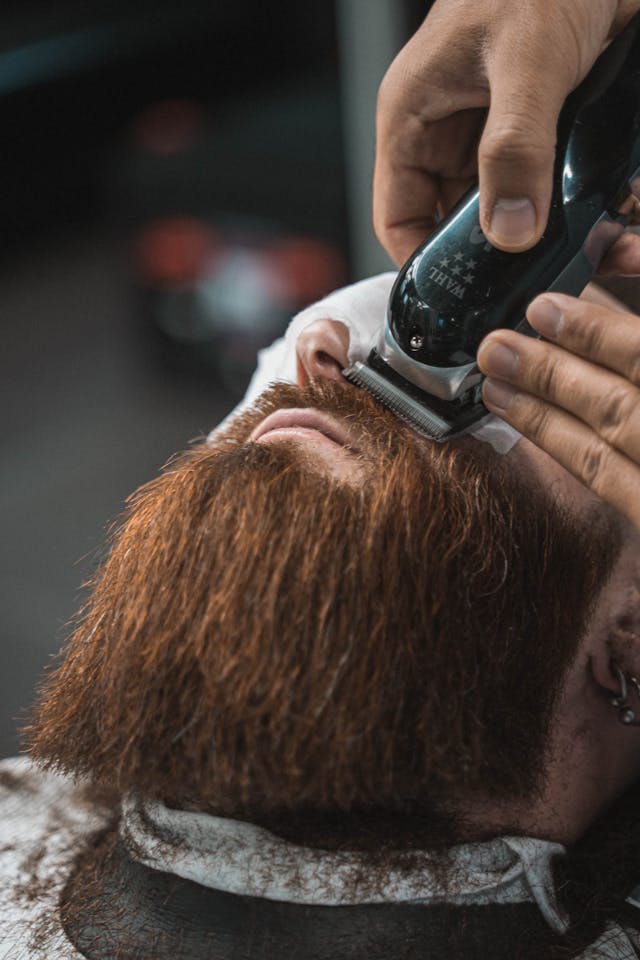 mustache and beard trim in barbers chair